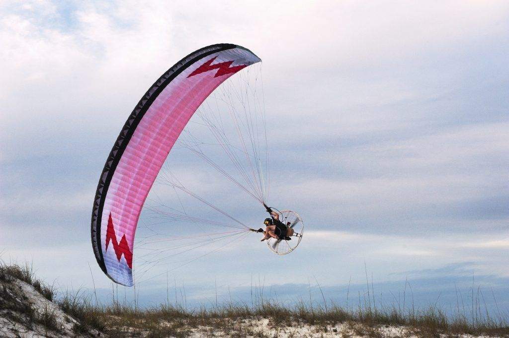 Man paragliding over beach against sky 1.jpg