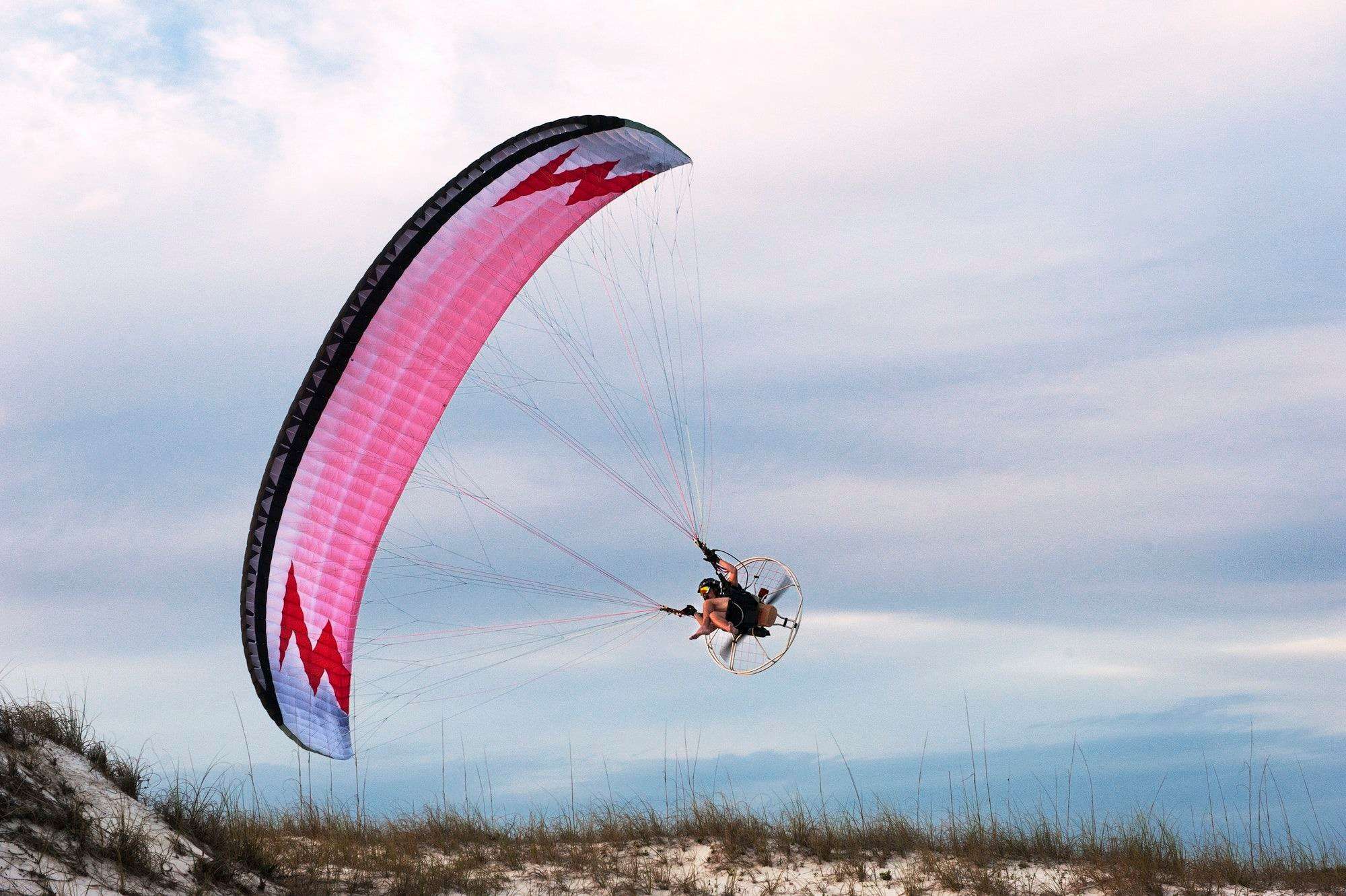 Man paragliding over beach against sky 1.jpg